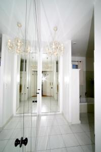 a bathroom with a glass shower and a mirror at La Bastide d'Andrea in Martignargues