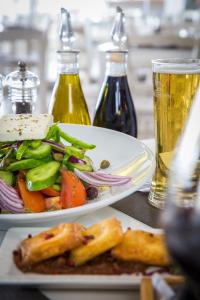 two plates of food and two glasses of beer at Island Boutique Hotel in Larnaca