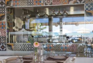 a table with a vase with a flower on it at Island Boutique Hotel in Larnaca