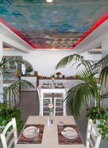 a dining room with a ceiling with a painting on it at Island Boutique Hotel in Larnaca