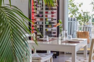 a white table and chairs in a room with a plant at Island Boutique Hotel in Larnaca