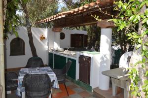 an outdoor kitchen with a table and chairs on a patio at B&B Il Giardino Segreto in Stromboli