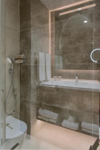 a bathroom with a shower and a sink and a toilet at Ankara Alegria Business Hotel in Ankara