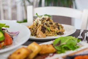 two plates of food on a table with food at Island Boutique Hotel in Larnaca