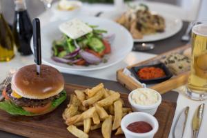 a tray of food with a hamburger and french fries at Island Boutique Hotel in Larnaca