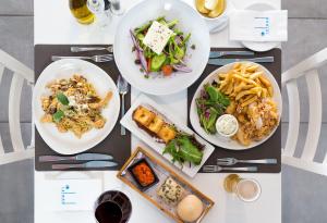 a table with three plates of food on it at Island Boutique Hotel in Larnaka