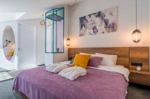 a bedroom with a purple bed with pillows on it at Redrum Tbilisi Boutique Hotel in Tbilisi City