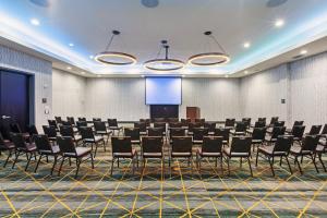 a conference room with chairs and a projection screen at Holiday Inn & Suites McKinney - N Allen by IHG in McKinney +43 photos