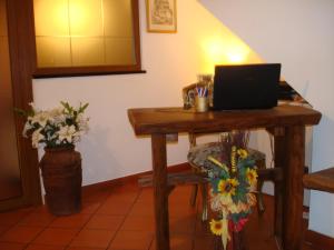 a wooden table with a laptop on top of it at affittacamere la loggia in Levanto