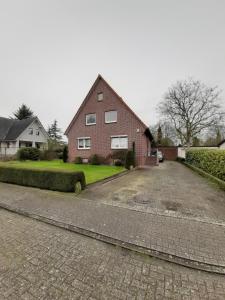 a brick house with a driveway in front of it at bei Maria + Kalle in Schortens