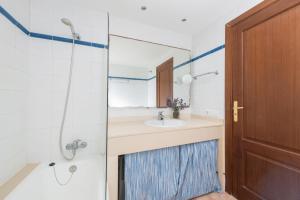 a bathroom with a sink and a shower at Burgit in Portopetro