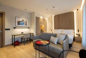 a hotel room with a couch and a bed at Zenit Convento San Martin in San Sebastián