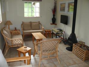 a living room filled with furniture and a fireplace at Crags Cottage in Nottingham Road