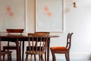 a dining room with a wooden table and chairs at Victorian House in Grasmere