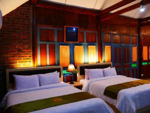 Voodi või voodid majutusasutuse D'Kaliurang Resort & Convention Yogyakarta toas