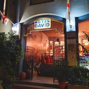 un hotel llamado hotel dayid con un perro sentado afuera en David Hotel - Ethno style, en Tiflis