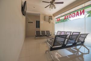 a waiting room with three chairs in a building at RedDoorz near Nagoya Citywalk Batam 2 in Nagoya