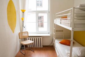 a bedroom with two bunk beds and a window at Amber Private Rooms in Riga