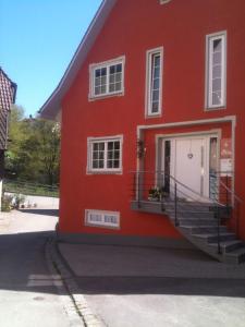a red house with a staircase in front of it at NEU ... in 2 min. am Bodensee in Überlingen