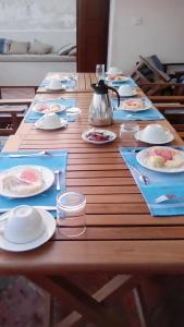 a long wooden table with plates of food on it at Beytsalam in Lamu
