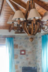 a chandelier hanging from a ceiling in a room at Maniatiko Village in Stoupa