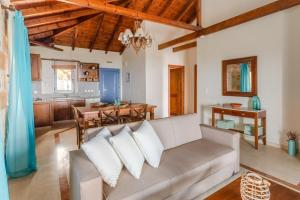 a living room with a couch and a table at Maniatiko Village in Stoupa