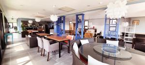 a restaurant with tables and chairs and a dining room at Dombe Resort in Seogwipo