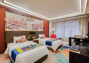 a hotel room with two beds and a desk at NagaWorld Hotel & Entertainment Complex in Phnom Penh