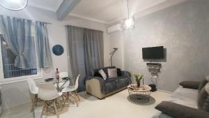 a living room with a couch and a table at Panorama Center apartment in Xanthi