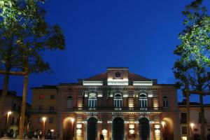 a building with lights in front of it at night at B&B Pretoria Suite in Potenza