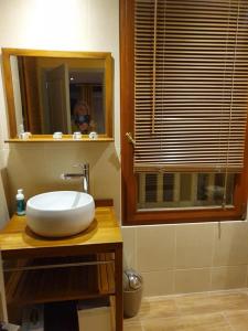 a bathroom with a white sink and a mirror at Bulle de sel in Caudan