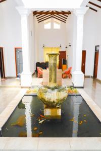 a large vase sitting in the middle of a room at HOSTEL KATUNAYAKE At COLOMBO AIRPORT TRANSIT in Katunayake