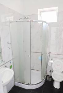 a bathroom with a shower and a toilet and a sink at HOSTEL KATUNAYAKE At COLOMBO AIRPORT TRANSIT in Katunayake
