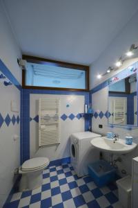 a blue and white bathroom with a toilet and a sink at Casa Amadi 2 - La tua casa lontano da casa in Brescia