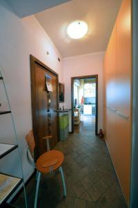 a hallway with a table and a chair in a room at Casa Amadi 2 - La tua casa lontano da casa in Brescia