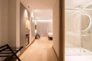 a bathroom with a shower and a bedroom at Zenit Convento San Martin in Donostia-San Sebastián