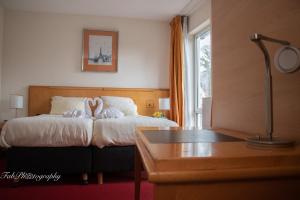 Postel nebo postele na pokoji v ubytování Hotel 2000 Valkenburg