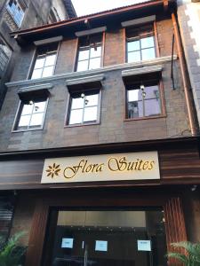 a store with a sign on the front of a building at Hotel Flora Suites - Fort in Mumbai