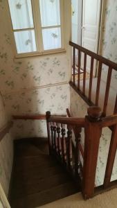 a staircase in a house with a window at Maison Commandant Blaison in Lapalisse