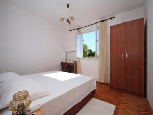 a bedroom with a white bed and a window at Rooms Vjera in Dubrovnik