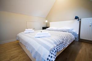 a bedroom with two beds with towels on them at Charming Triplex near Avenue Louise in Brussels