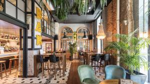 a restaurant with tables and chairs and a bar at Gran Vía Apartment in Madrid