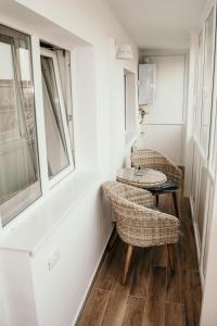 a room with a table and chairs and a window at Apartament de lux ultramodern in zona centrala in Timişoara