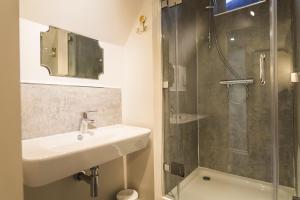 a bathroom with a sink and a shower at The Rose & Crown in Godalming