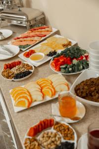 um buffet com muitos tipos diferentes de comida em uma mesa em Merci Hotel em Tashkent