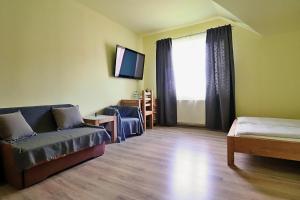 a living room with a couch and a large window at BedRooms 3 Maja 15A in Łódź