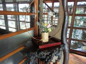 a mirror on a table with a potted plant at Hoshidekan in Ise