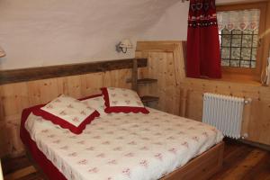 a bedroom with a bed with two pillows on it at Maison Peroulaz in Charvensod