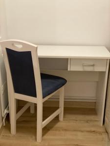 a white desk with a chair next to it at Take PRO Timisoara Apartment in Timişoara