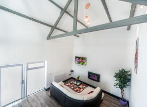 a living room with a couch and a tv at Curragh House Lodges in Kinsale